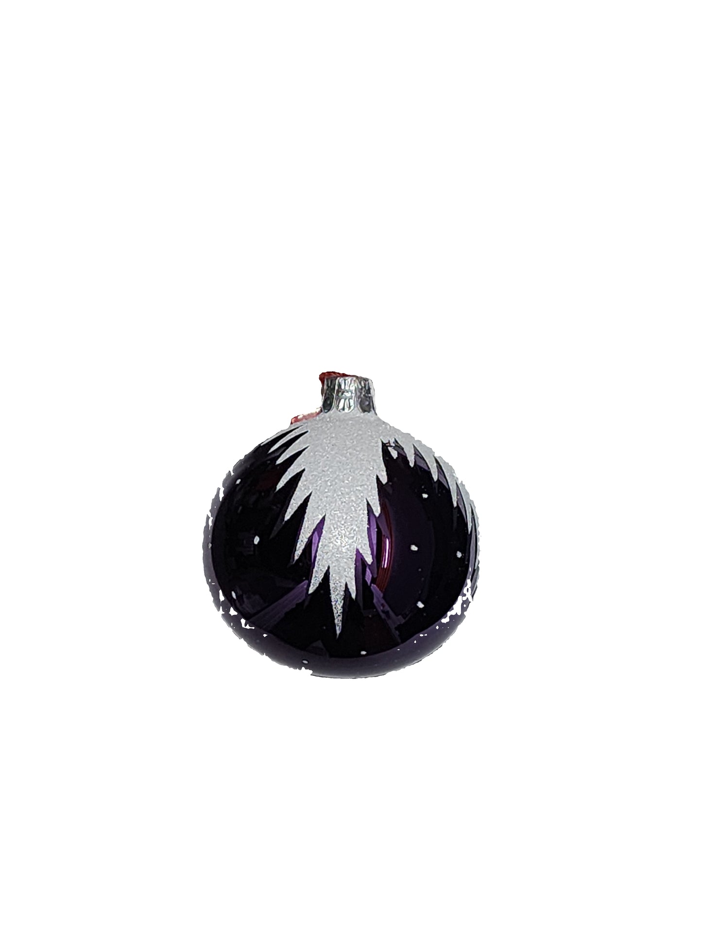 A glass ornament with a purple and white design on a white surface.