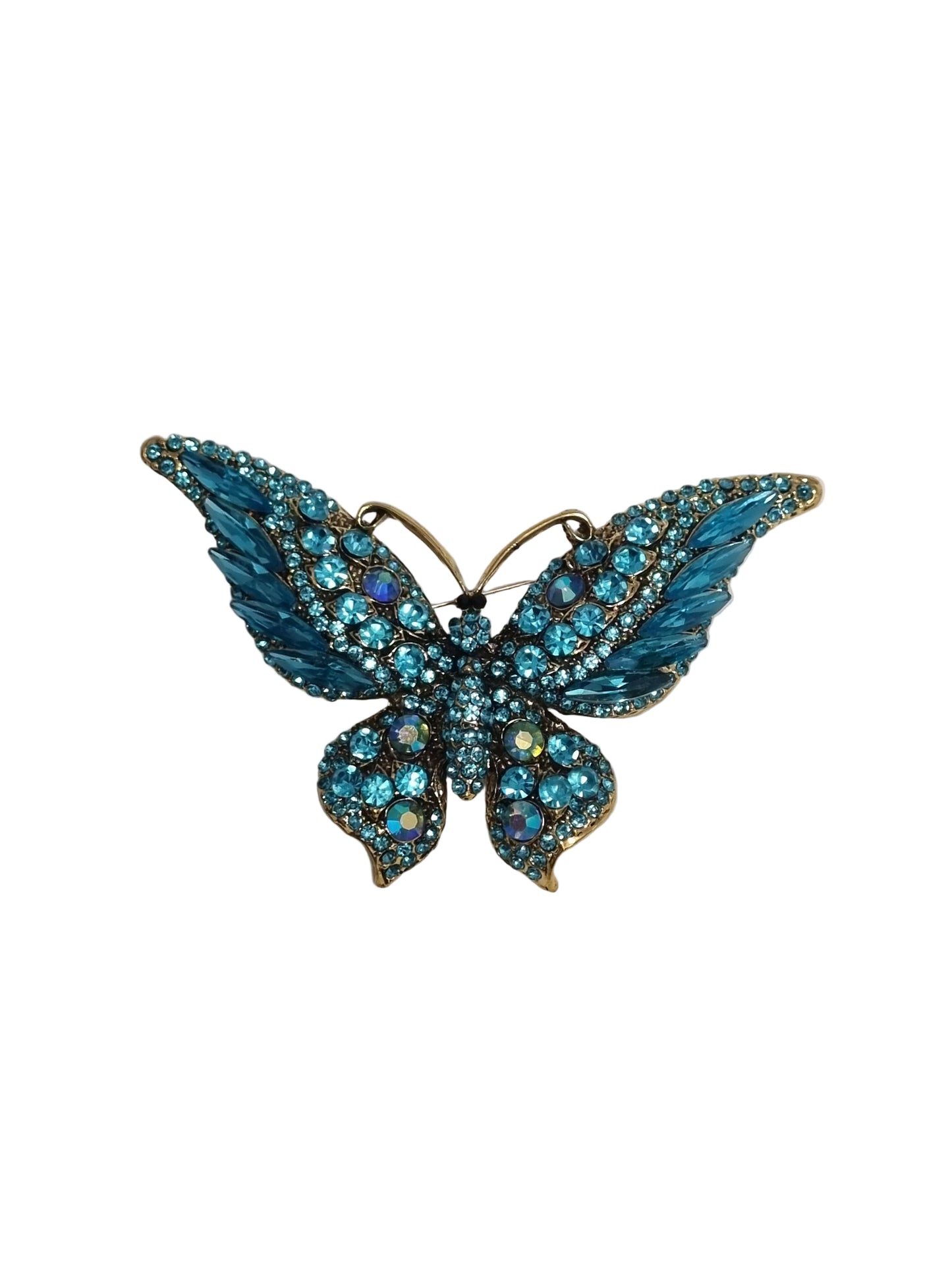 Blue butterfly-shaped brooch with gemstones on a light gray background