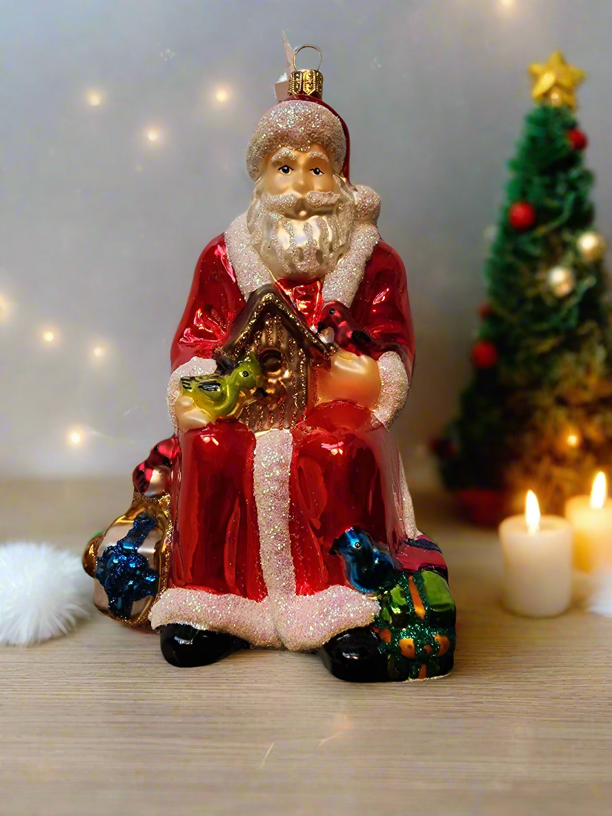 European Glass Christmas ornament of a Santa | Seated with Birdhouse (Z)