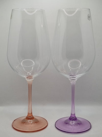 Two red wine glasses with red and purple stems on a white background