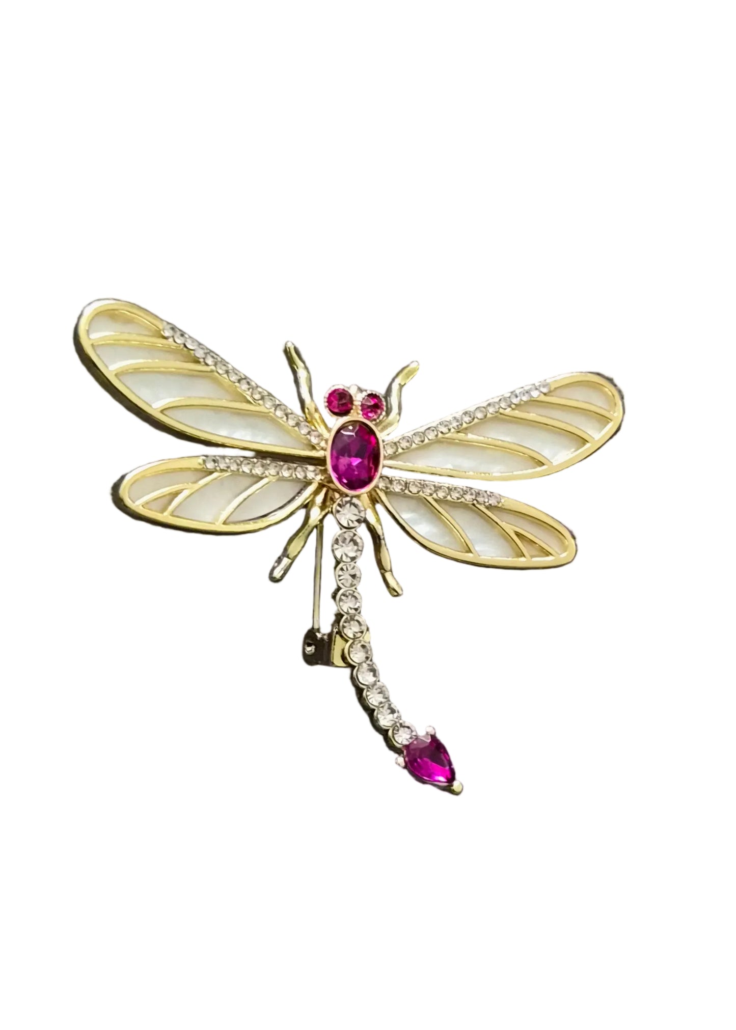 A gold dragonfly brooch with white enamel wings and pink gemstone accents.