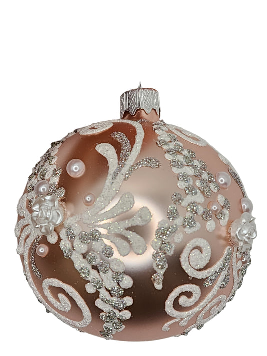 Decorative Christmas ornament with intricate designs against a neutral background