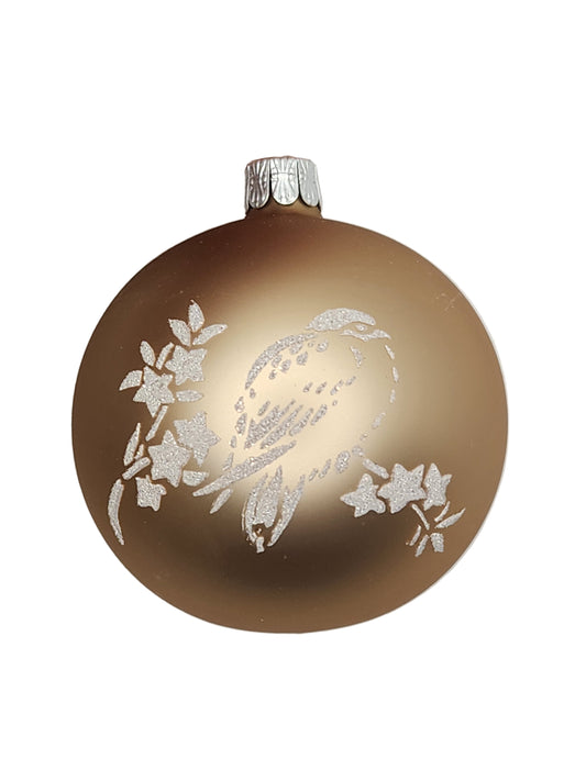 Decorative brown ornament with white floral patterns held by a hand on a light gray background